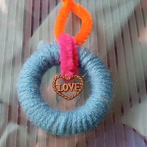 Blue yarn wrapped ornament with Love Charm